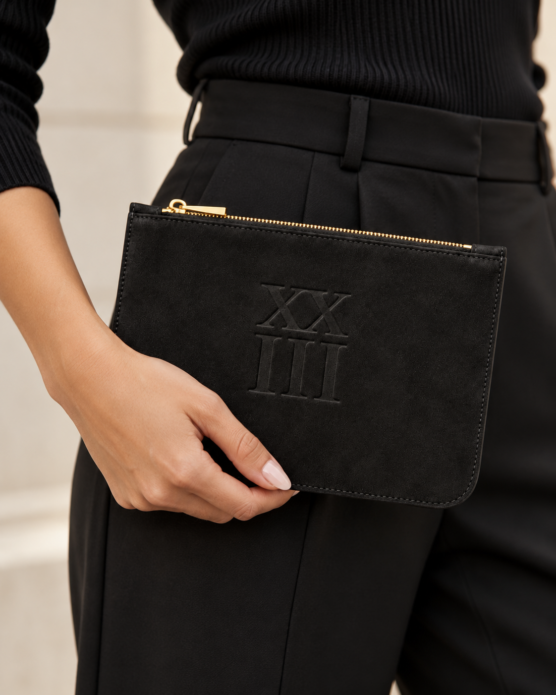 XXIII Audrey Zip Pouch in Black Suede, handheld lifestyle view